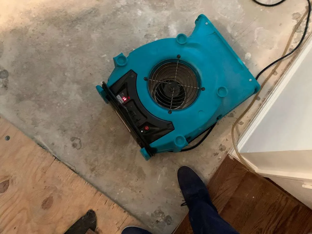 Air mover drying subfloor during Commercial Water Damage Restoration in Richland Hills